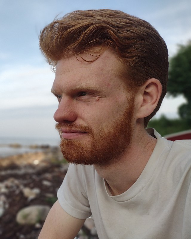 Ian McPherson looking out over a rocky shoreline